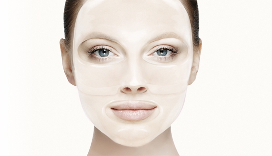 a lady applying hydrogel mask on the face